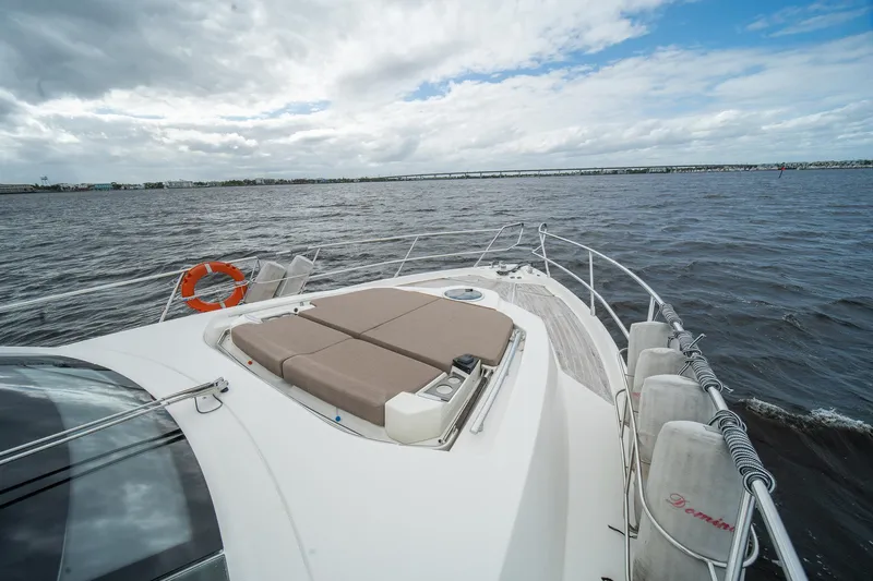 Dominus Yacht Photos Pics 2012 Cranchi 56 yacht on open water with sunbathing area.