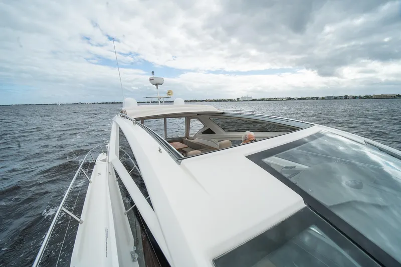 Dominus Yacht Photos Pics 2012 Cranchi 56 yacht cruising on open water under cloudy skies.