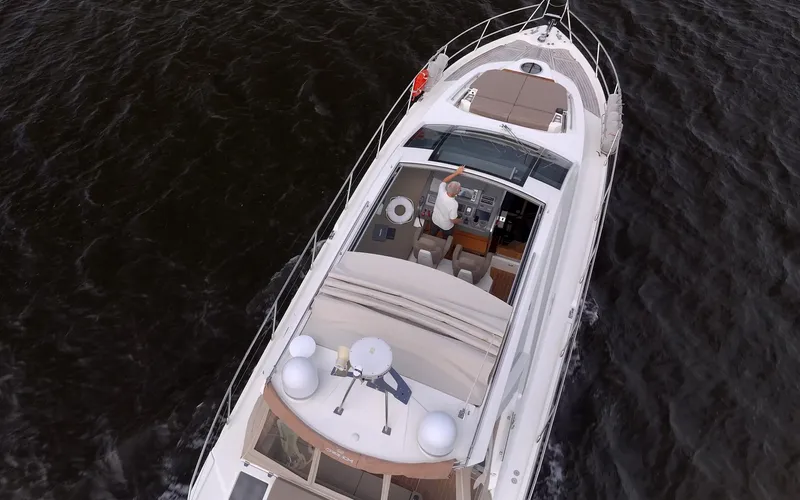 Dominus Yacht Photos Pics Aerial view of a 2012 Cranchi 56 yacht cruising on the water.