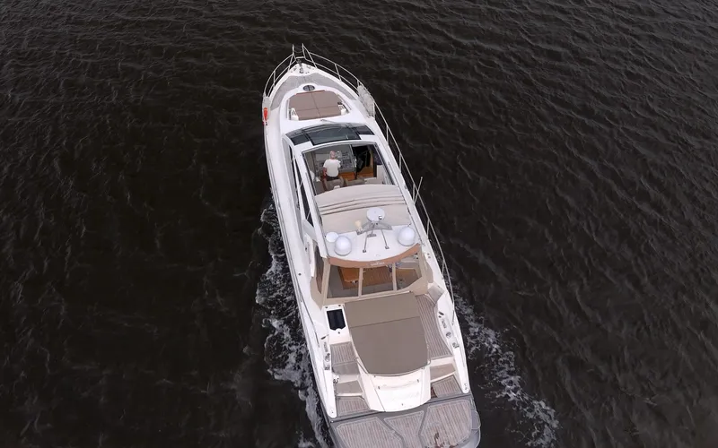 Dominus Yacht Photos Pics Aerial view of 2012 Cranchi 56 yacht cruising on dark waters.