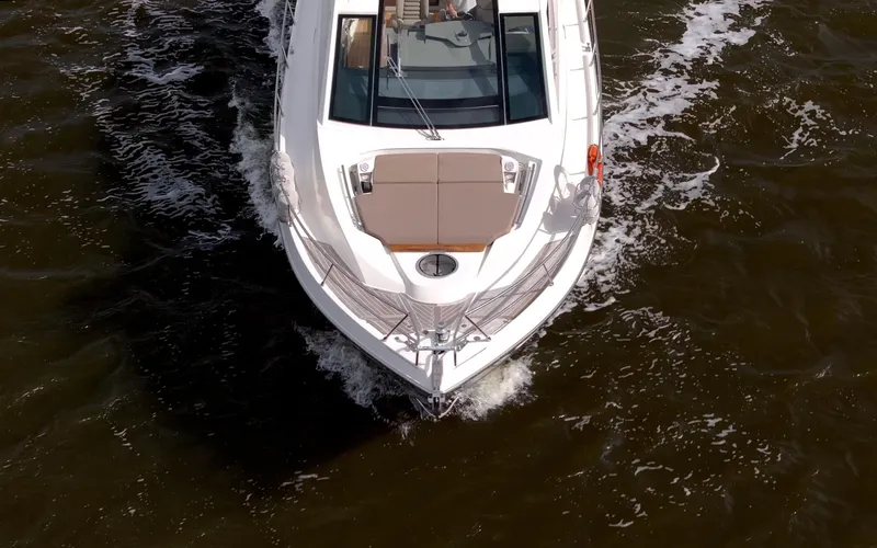 Dominus Yacht Photos Pics Top view of a 2012 Cranchi 56 yacht cruising on water.