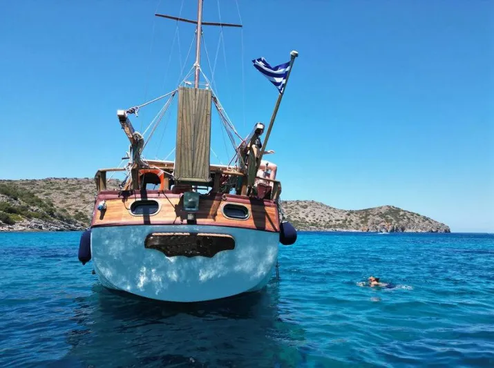  Yacht Photos Pics Traditional motor sailer in clear blue waters, 1981 model, with Greek flag.