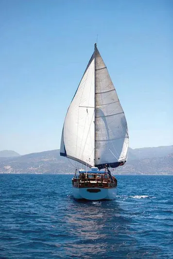  Yacht Photos Pics Traditional motor sailer on open sea, 1981 model, sailing under clear blue skies.