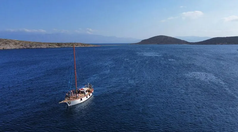  Yacht Photos Pics Traditional motor sailer on open sea, clear skies, distant islands; 1981 Custom model, 13.59m length.