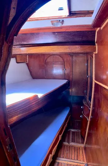  Yacht Photos Pics Interior of a 1981 Custom Traditional Motor Sailer, featuring wooden bunk beds and cabinetry.
