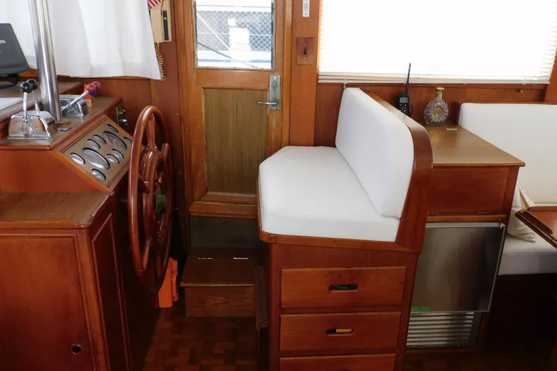 Susan Gail Yacht Photos Pics Interior helm of 1986 Grand Banks 46 Classic yacht with wooden steering wheel and seating.