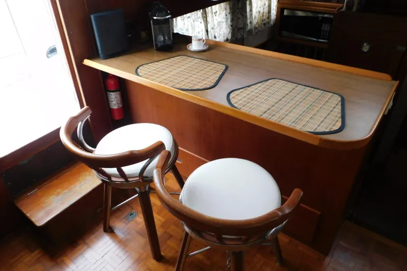 Susan Gail Yacht Photos Pics Interior of 1986 Grand Banks 46 Classic yacht with bar stools and wooden counter.