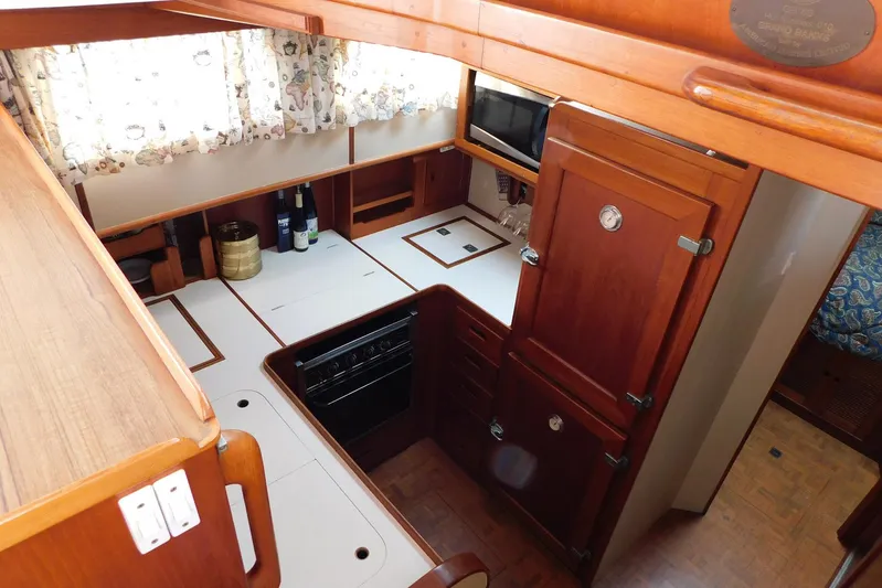 Susan Gail Yacht Photos Pics 1986 Grand Banks 46 Classic yacht kitchen with wood cabinetry and modern appliances.