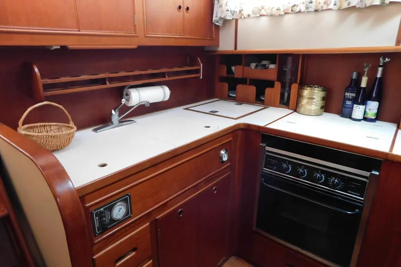 Susan Gail Yacht Photos Pics 1986 Grand Banks 46 Classic yacht kitchen with wood cabinetry and modern appliances.