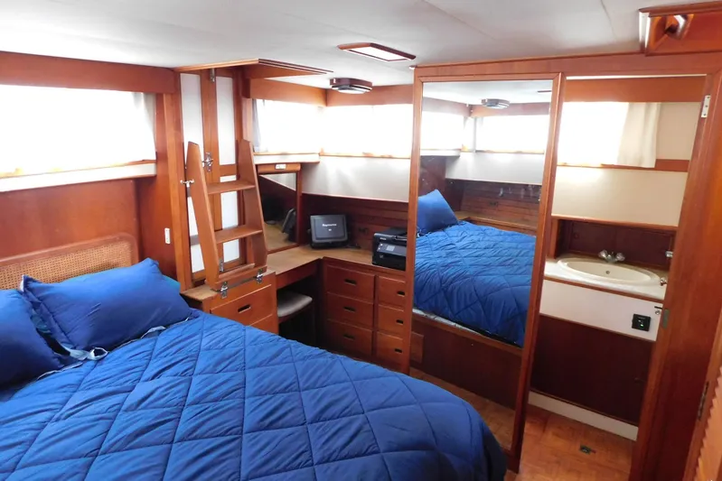 Susan Gail Yacht Photos Pics Interior of 1986 Grand Banks 46 Classic yacht with blue bedding and wooden furnishings.