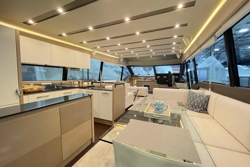 Total Package Yacht Photos Pics Luxurious interior of 2016 Prestige 680 Flybridge yacht with modern kitchen and seating area.
