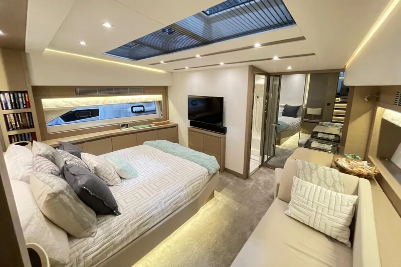 Total Package Yacht Photos Pics Luxurious bedroom interior of 2016 Prestige 680 Flybridge yacht with modern decor and skylight.