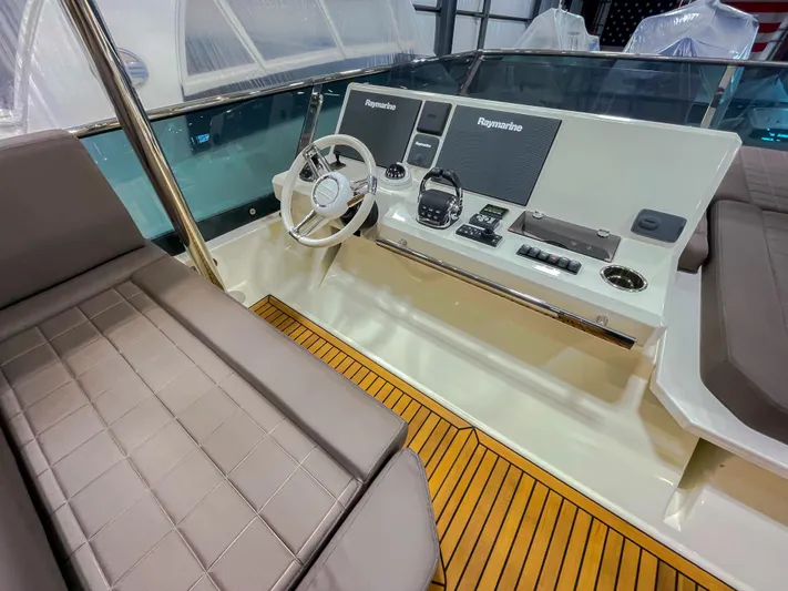 Total Package Yacht Photos Pics Prestige 680 Flybridge 2016 helm with modern controls and comfortable seating.