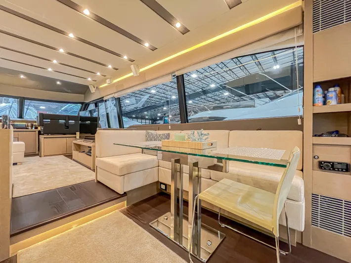Total Package Yacht Photos Pics Luxurious interior of 2016 Prestige 680 Flybridge yacht with modern seating and glass table.