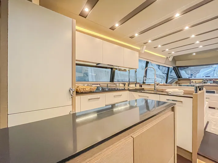 Total Package Yacht Photos Pics Luxurious kitchen interior of 2016 Prestige 680 Flybridge yacht with modern design.