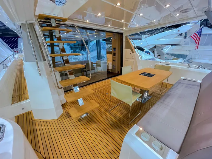 Total Package Yacht Photos Pics Luxurious 2016 Prestige 680 Flybridge yacht interior with elegant wood flooring and modern dining area.