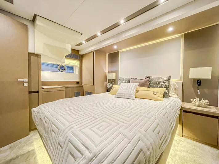 Total Package Yacht Photos Pics Luxurious bedroom interior of 2016 Prestige 680 Flybridge yacht, featuring elegant design and cozy ambiance.