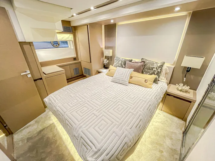 Total Package Yacht Photos Pics Luxurious bedroom interior on 2016 Prestige 680 Flybridge yacht, featuring elegant bedding and ambient lighting.