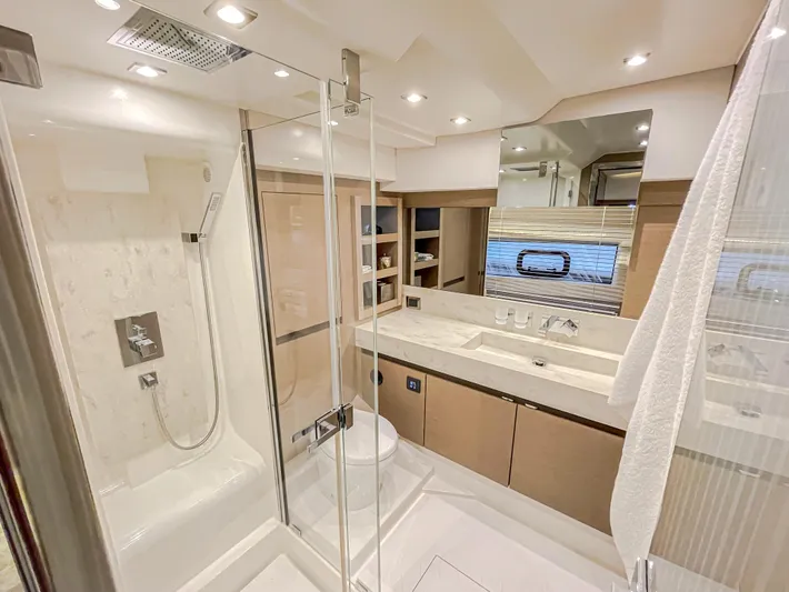 Total Package Yacht Photos Pics Luxurious bathroom in 2016 Prestige 680 Flybridge yacht with modern fixtures and spacious shower.