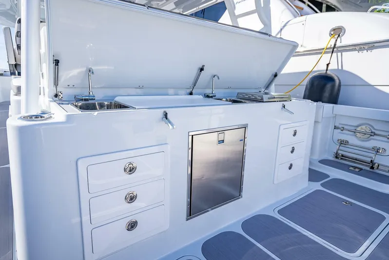 54 Offshore Yacht Photos Pics 2024 Yellowfin 54 Offshore boat kitchen area with storage drawers and sink.
