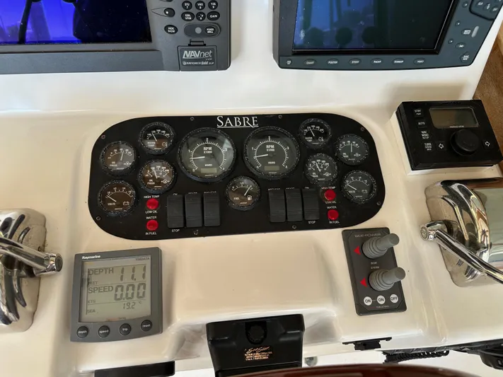 Bay Saddle Yacht Photos Pics Control panel of a 2005 Sabre 38 Hardtop Express boat with various gauges and displays.