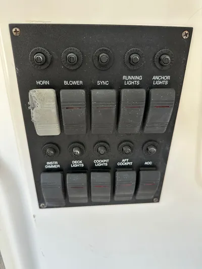 Bay Saddle Yacht Photos Pics Control panel of a 2005 Sabre 38 Hardtop Express boat with labeled switches.