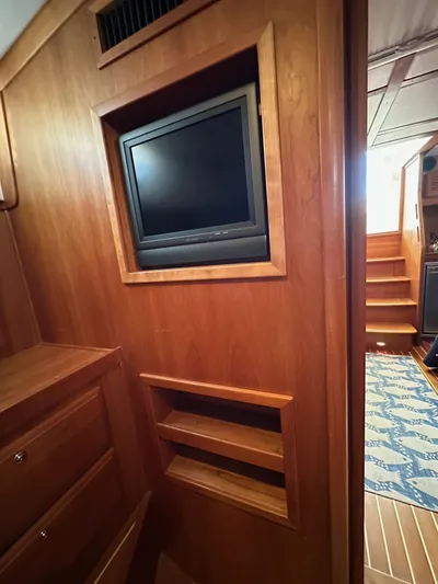 Bay Saddle Yacht Photos Pics 2005 Sabre 38 Hardtop Express interior with built-in TV and wooden cabinetry.