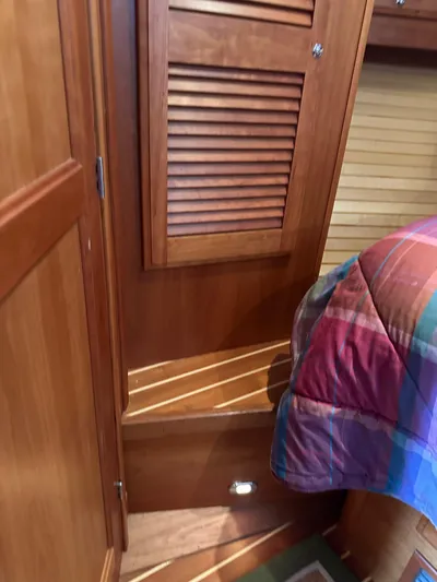 Bay Saddle Yacht Photos Pics Interior of 2005 Sabre 38 Hardtop Express with wooden cabinetry and colorful bedding.