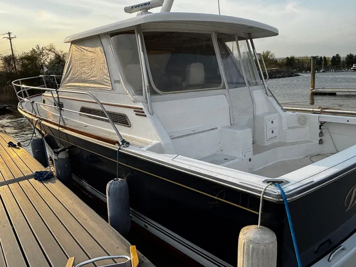 Bay Saddle Yacht Photos Pics 2005 Sabre 38 Hardtop Express docked at marina, featuring sleek design and enclosed cabin.