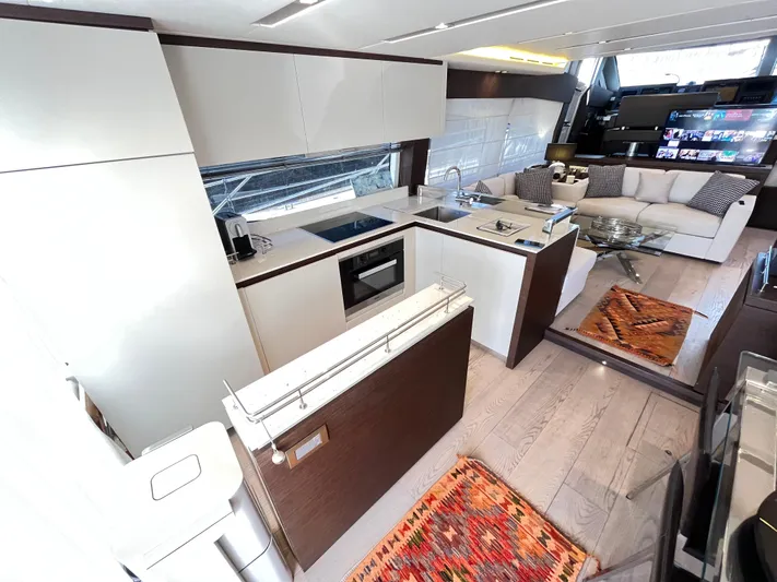 Princess Of The Seas Yacht Photos Pics Luxurious interior of 2017 Jeanneau Prestige 750 yacht with modern kitchen and cozy seating area.