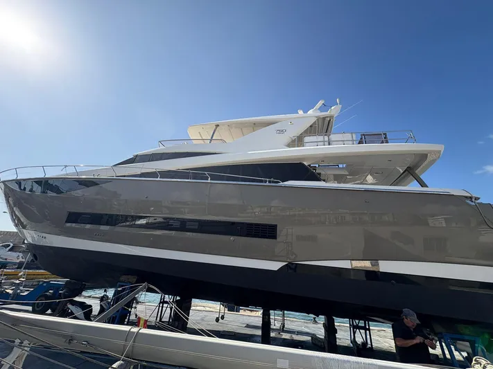 Princess Of The Seas Yacht Photos Pics 2017 Jeanneau Prestige 750 yacht on dry dock under clear blue sky.