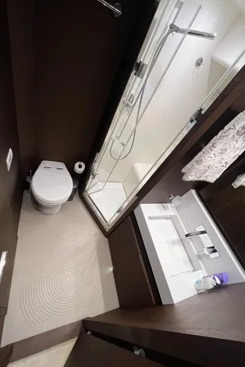 Princess Of The Seas Yacht Photos Pics Bathroom interior of 2017 Jeanneau Prestige 750 yacht with shower, sink, and toilet.
