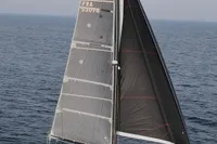 2018 Outremer 4X catamaran sailing on open sea, showcasing sleek design and performance.