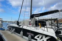 2018 Outremer 4X catamaran docked at marina under cloudy sky.