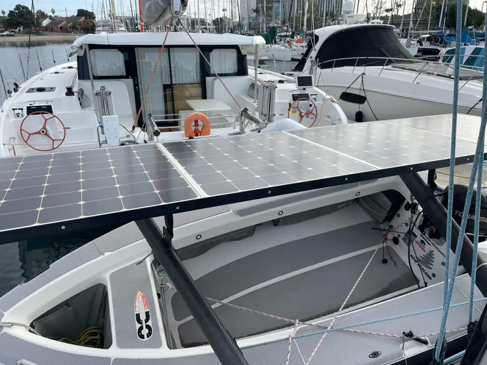 Inconceivable Yacht Photos Pics 2018 Outremer 4X catamaran with solar panels docked at a marina.