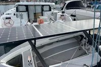 2018 Outremer 4X catamaran with solar panels docked at a marina.