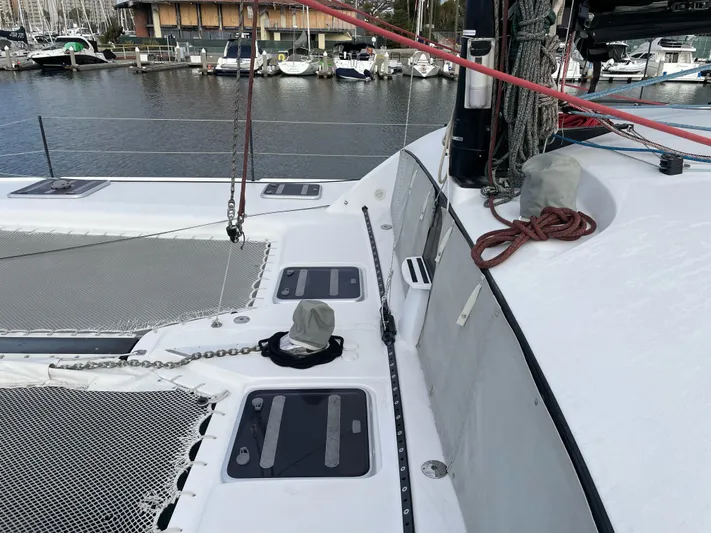 Inconceivable Yacht Photos Pics 2018 Outremer 4X catamaran deck with netting and ropes, docked in a marina.