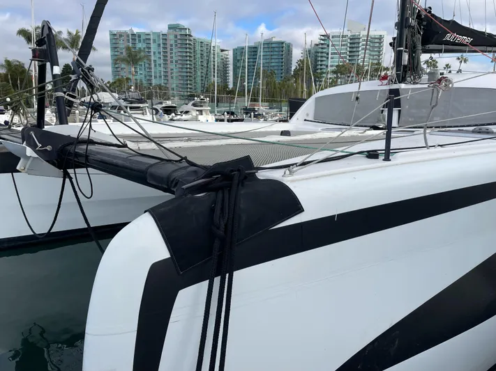 Inconceivable Yacht Photos Pics Outremer 4X 2018 catamaran docked in marina with modern buildings in background.