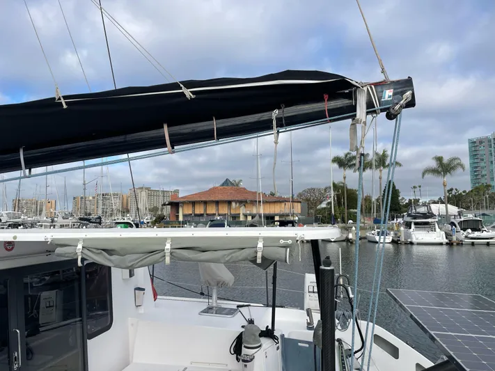 Inconceivable Yacht Photos Pics 2018 Outremer 4X catamaran docked in a marina with solar panels and cityscape background.