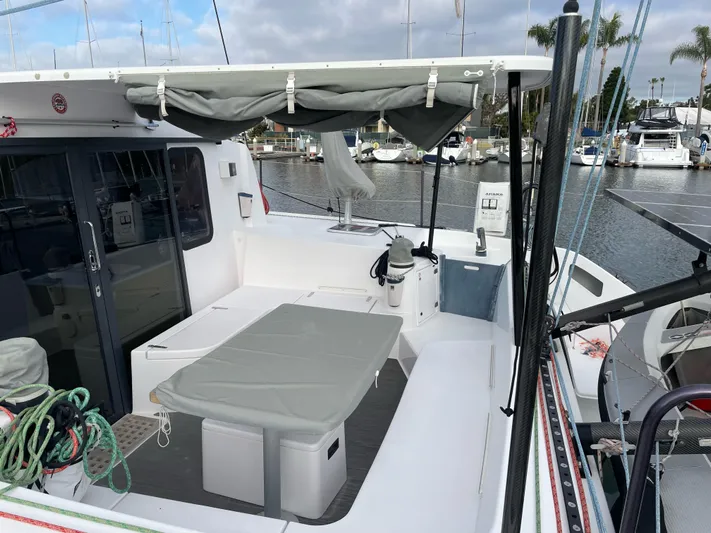 Inconceivable Yacht Photos Pics 2018 Outremer 4X catamaran deck with seating, table, and marina view.