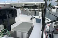 2018 Outremer 4X catamaran deck with seating, table, and marina view.
