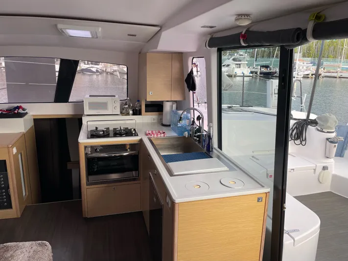 Inconceivable Yacht Photos Pics Interior of 2018 Outremer 4X catamaran with modern kitchen and marina view.