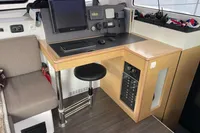 Navigation station in 2018 Outremer 4X catamaran with control panel and seating.