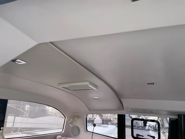 Inconceivable Yacht Photos Pics Interior view of 2018 Outremer 4X catamaran, featuring sleek ceiling design and windows.