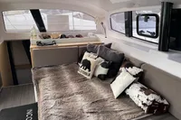 Interior of 2018 Outremer 4X catamaran with cozy seating and decorative pillows.