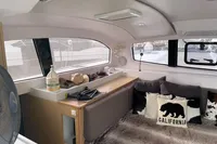 Interior of 2018 Outremer 4X catamaran with cozy seating and California-themed decor.