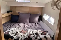 Cozy cabin interior of 2018 Outremer 4X with plush bedding and natural light.