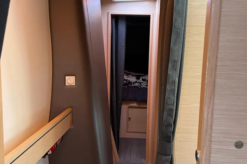 Inconceivable Yacht Photos Pics Interior hallway of 2018 Outremer 4X yacht, featuring wooden paneling and cozy cabin entrance.