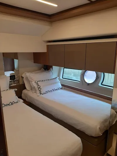  Yacht Photos Pics Luxurious cabin interior of 2020 Intermarine 80 yacht with twin beds and porthole window.