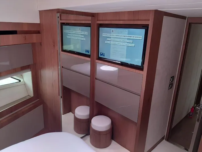  Yacht Photos Pics Luxurious Intermarine 80 yacht interior, featuring modern wood paneling and dual wall-mounted screens, 2020 model.